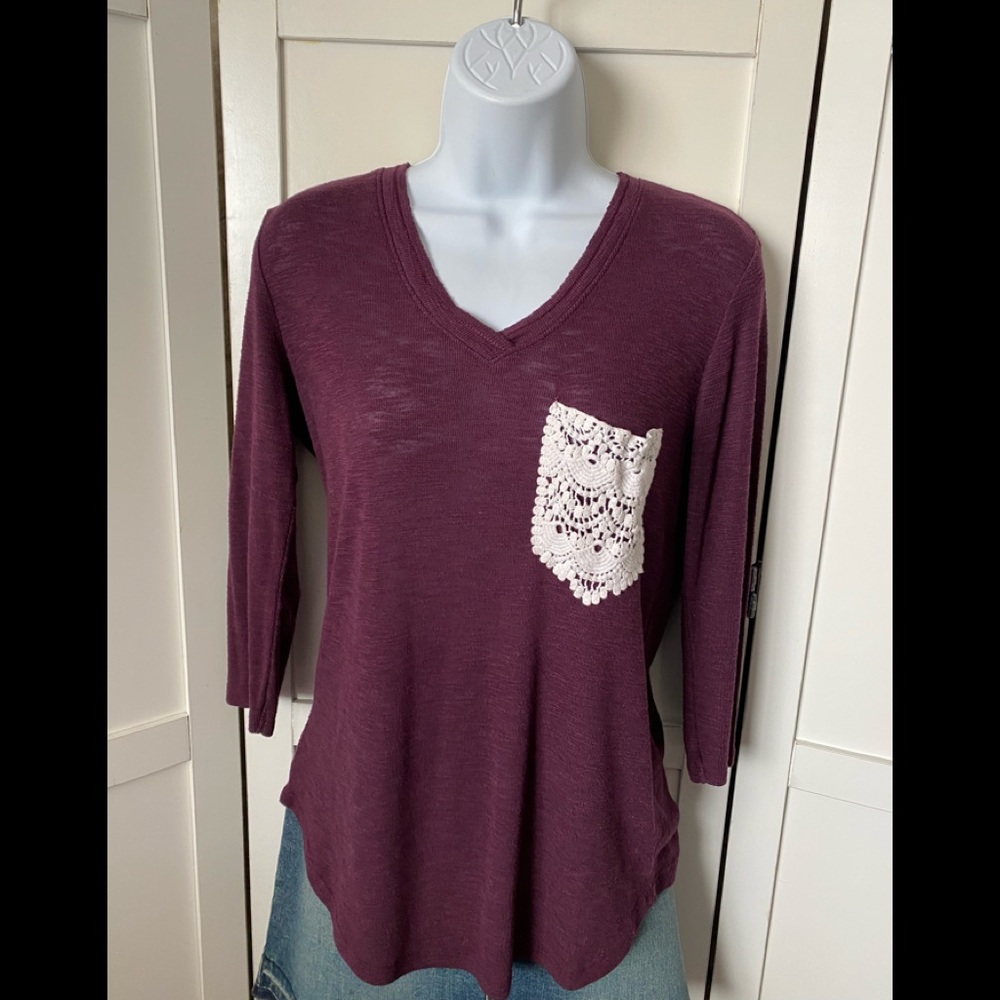 Go Wild top mid sleeves. Pocket in front. Size Med.